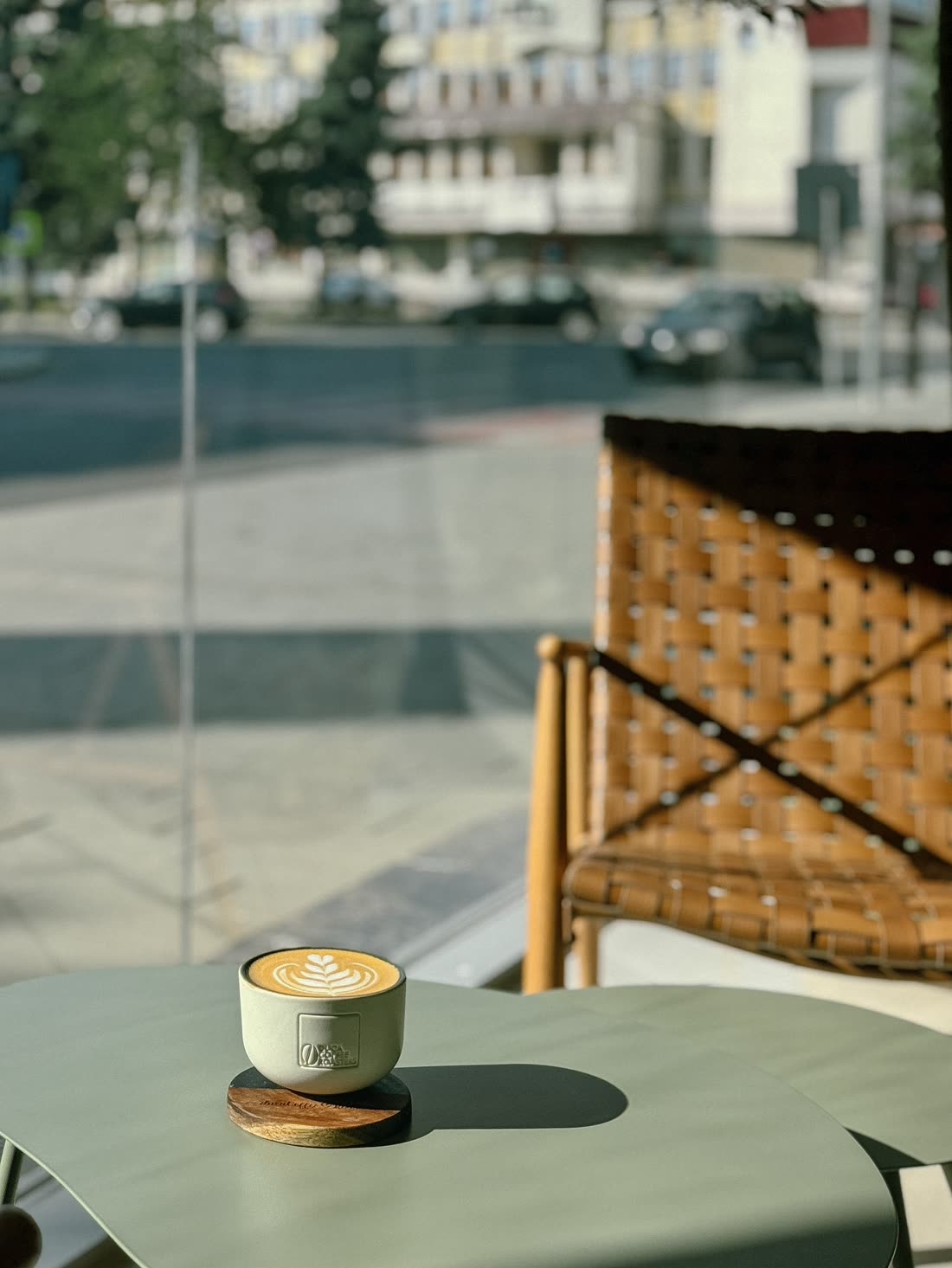 Latte art on a wooden shelf by the shop window
